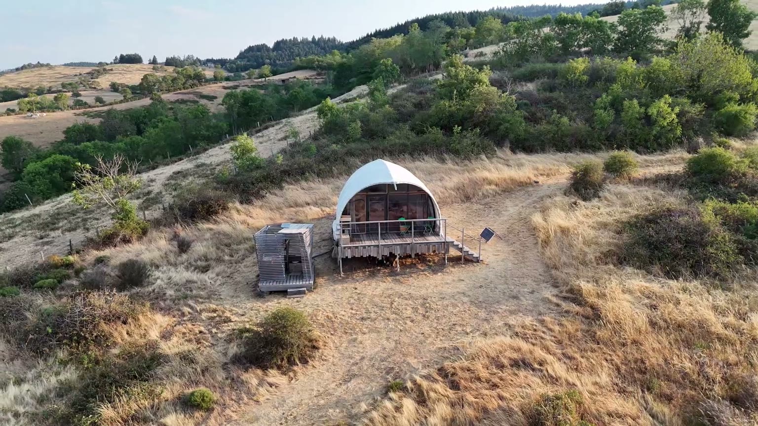 Vue aérienne du dôme Symbiome au couchant sur les collines de la Côte Roannaise
